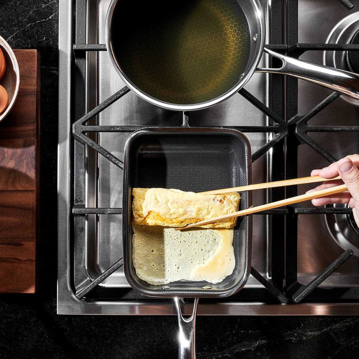 A rolled omelette cooking in HexClad's rectangular egg pan, seen from above