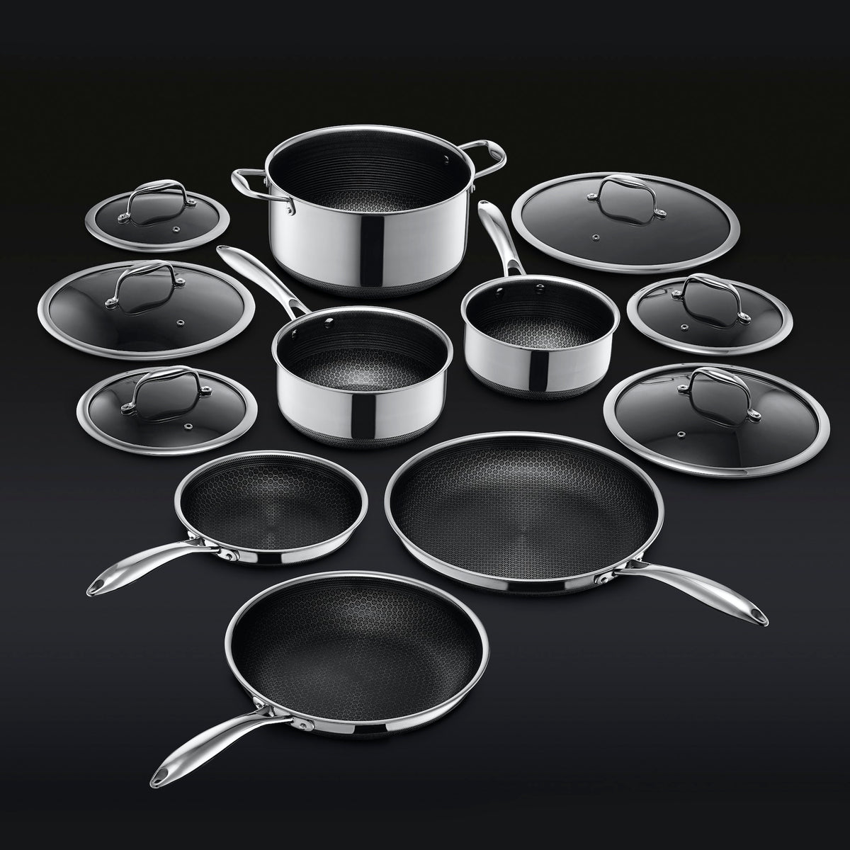HexClad's twelve piece pots and pans set laid out on a black background